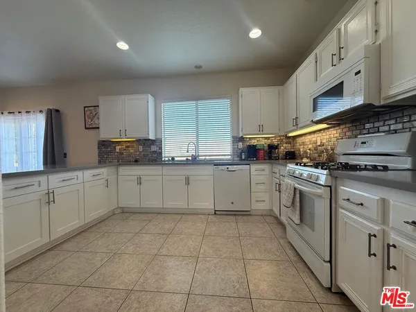a kitchen with stainless steel appliances granite countertop a sink and cabinets