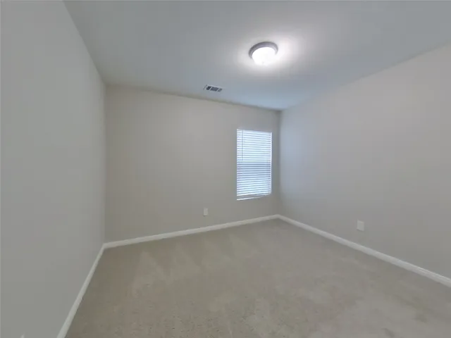 an empty room with a empty space and windows