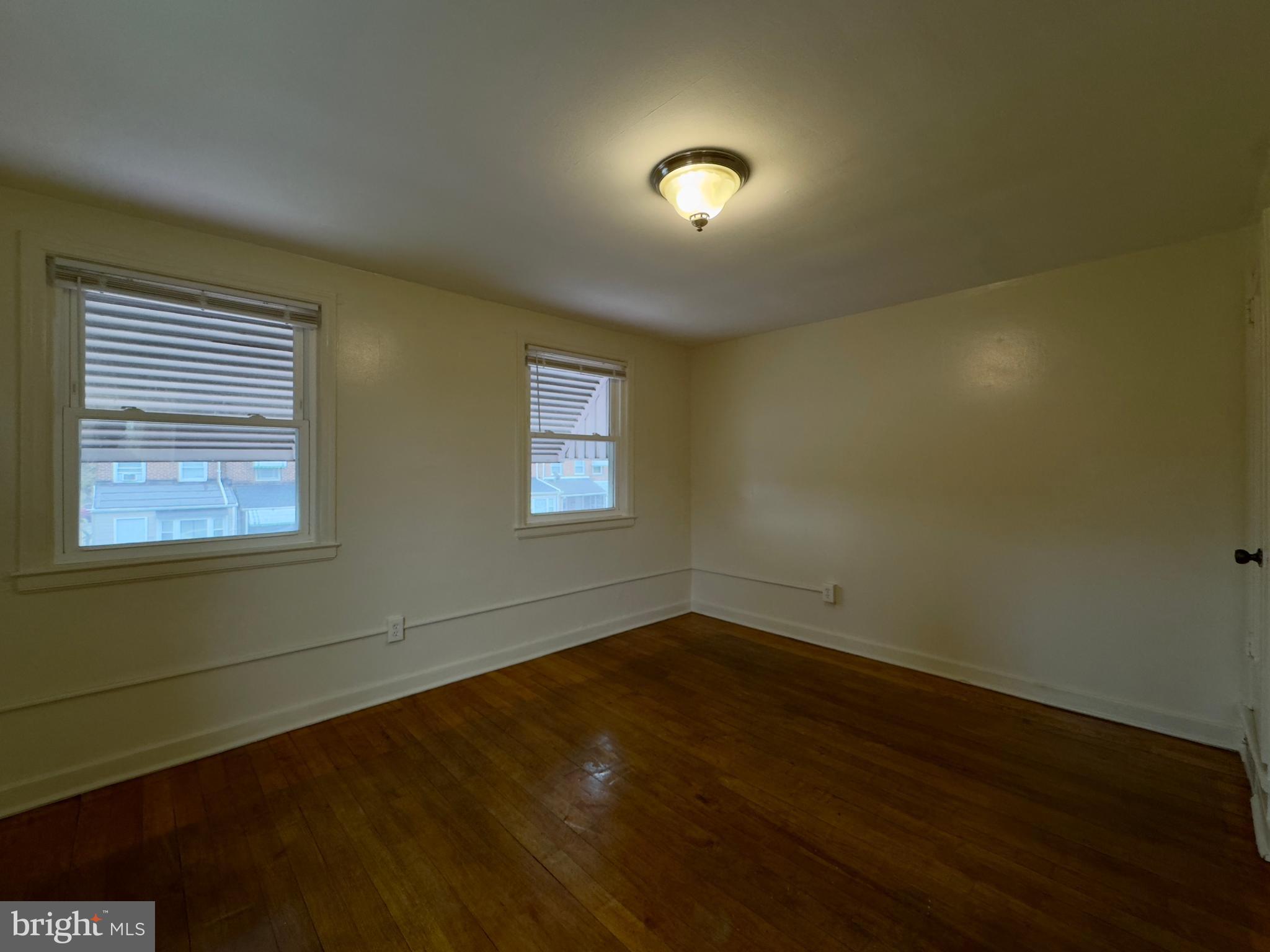 116 Carver Road Dundalk, MD 21222 - Photo 15 of 19 a view of an empty room with wooden floor and a window