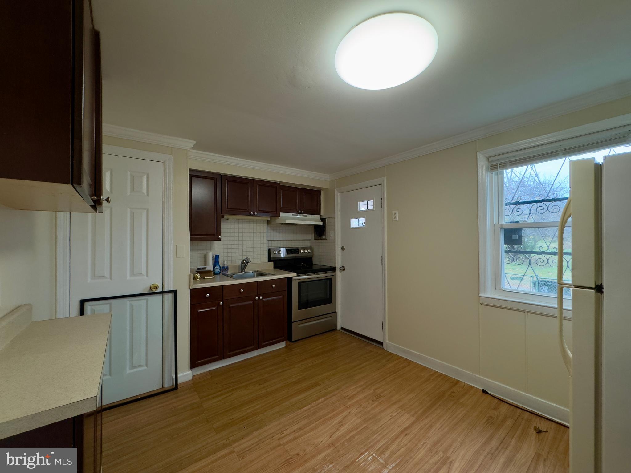 116 Carver Road Dundalk, MD 21222 - Photo 6 of 19 a kitchen with stainless steel appliances granite countertop a stove a sink and a refrigerator