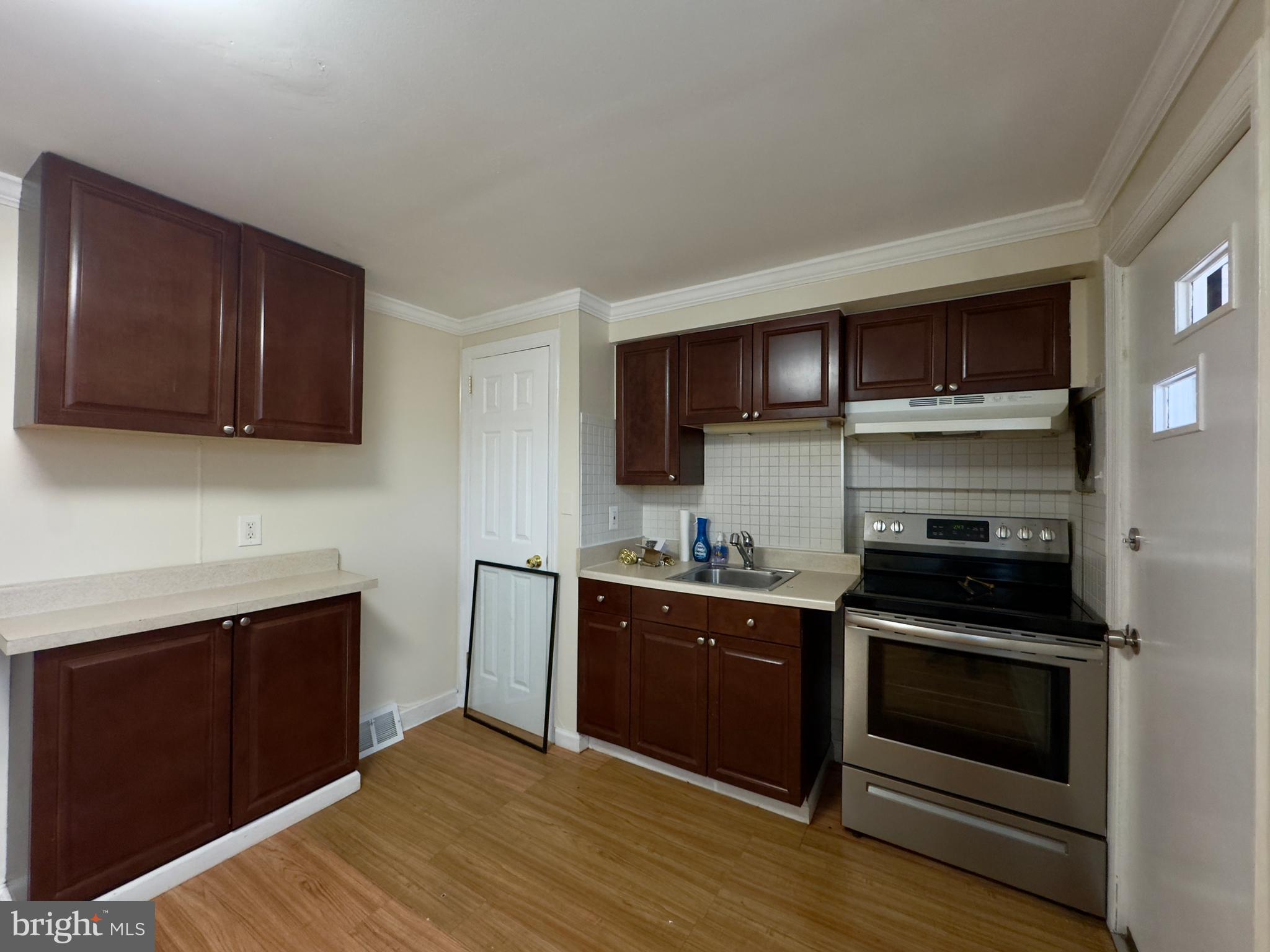 116 Carver Road Dundalk, MD 21222 - Photo 7 of 19 a kitchen with a stove and a microwave