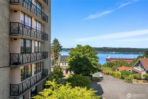 an aerial view of a house with balcony and trees al around