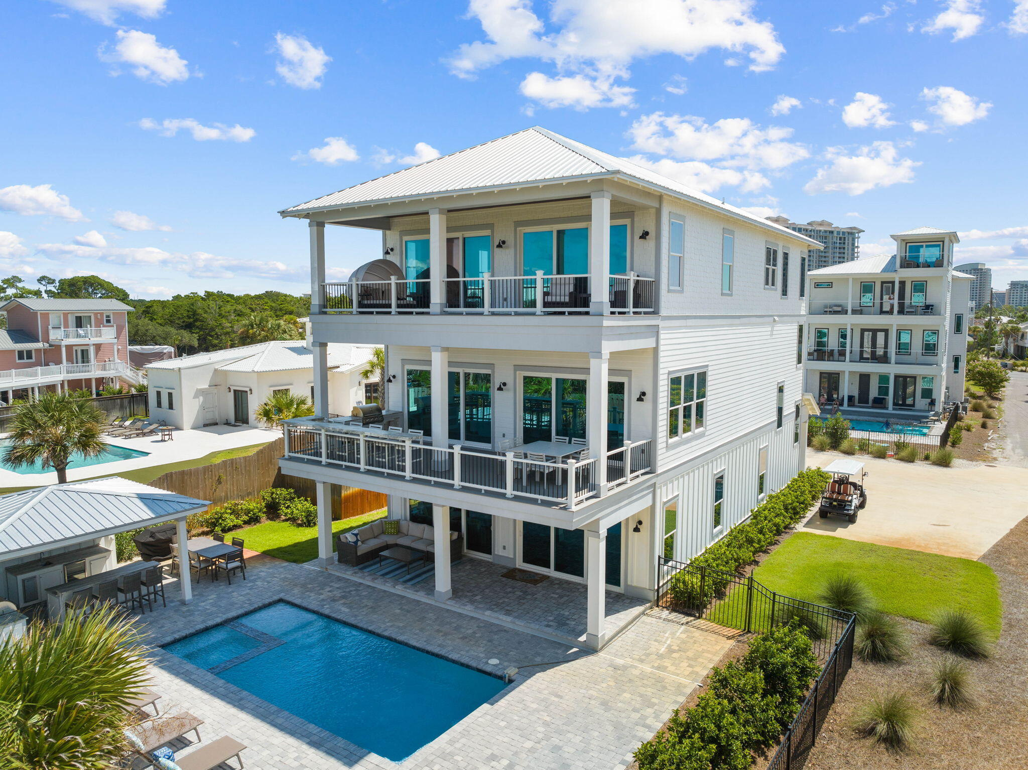 102 Overlook Circle Miramar Beach, FL 32550 - Photo 34 of 38 a view of a white building with a swimming pool and outdoor seating