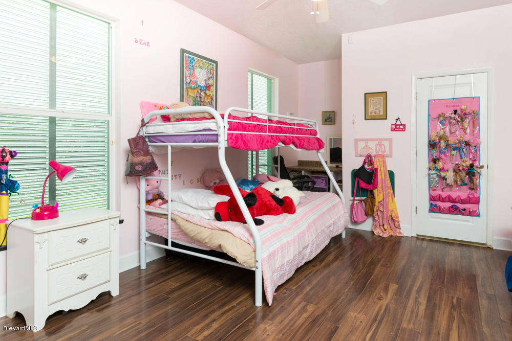 4175 Turtle Mound Road Melbourne, FL 32934 - Photo 13 of 26 a bedroom with a bed and a window