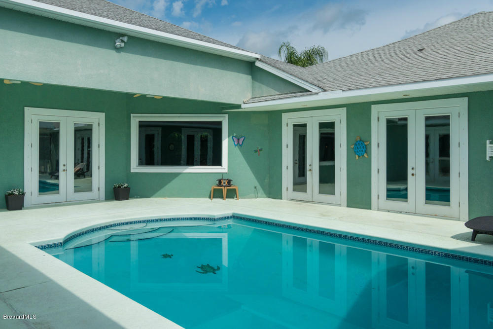 4175 Turtle Mound Road Melbourne, FL 32934 - Photo 19 of 26 a view of a house with pool and porch