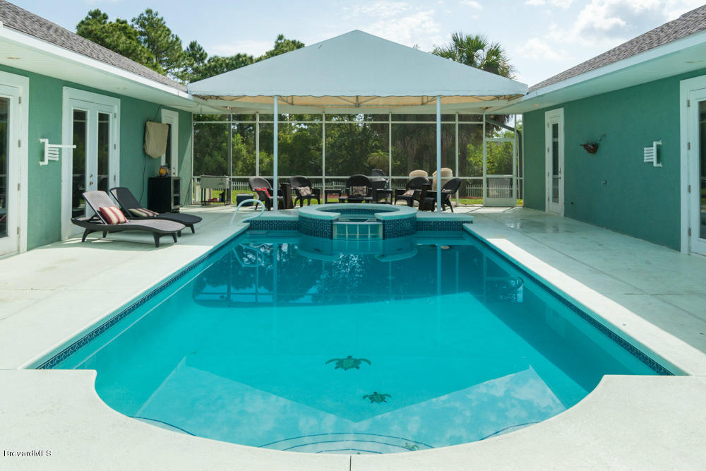 4175 Turtle Mound Road Melbourne, FL 32934 - Photo 20 of 26 a view of a swimming pool with a patio