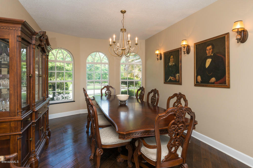 4175 Turtle Mound Road Melbourne, FL 32934 - Photo 3 of 26 a view of a dining room with furniture window and wooden floor