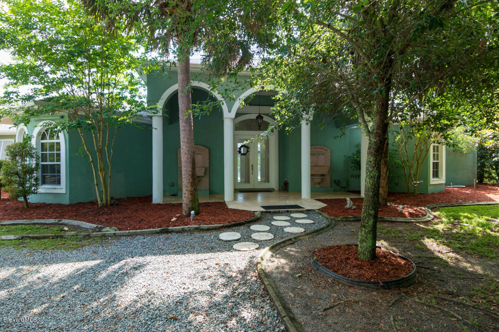 4175 Turtle Mound Road Melbourne, FL 32934 - Photo 25 of 26 a front view of a house with a yard