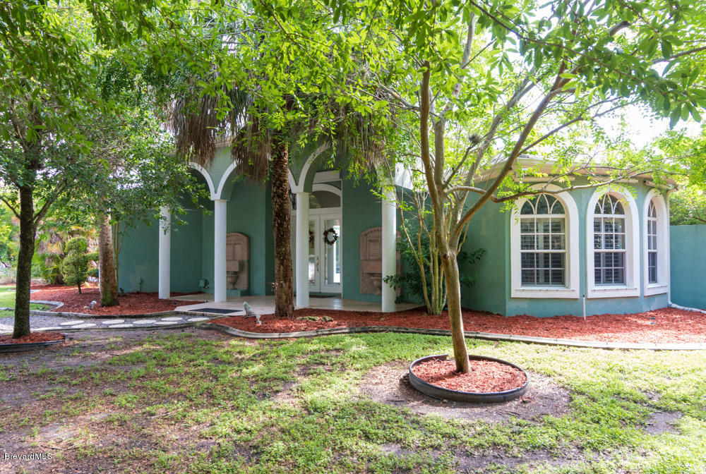 4175 Turtle Mound Road Melbourne, FL 32934 - Photo 26 of 26 a front view of a house with a yard