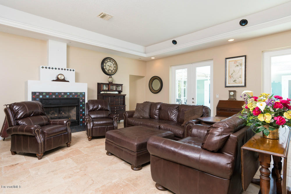 4175 Turtle Mound Road Melbourne, FL 32934 - Photo 4 of 26 a living room with furniture a clock and a window