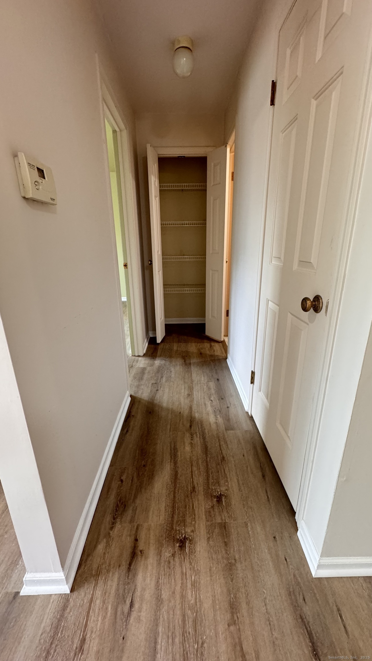 25 Janet Circle, Unit F Bridgeport, CT 06606 - Photo 11 of 23 a view of a hallway with wooden floor and staircase