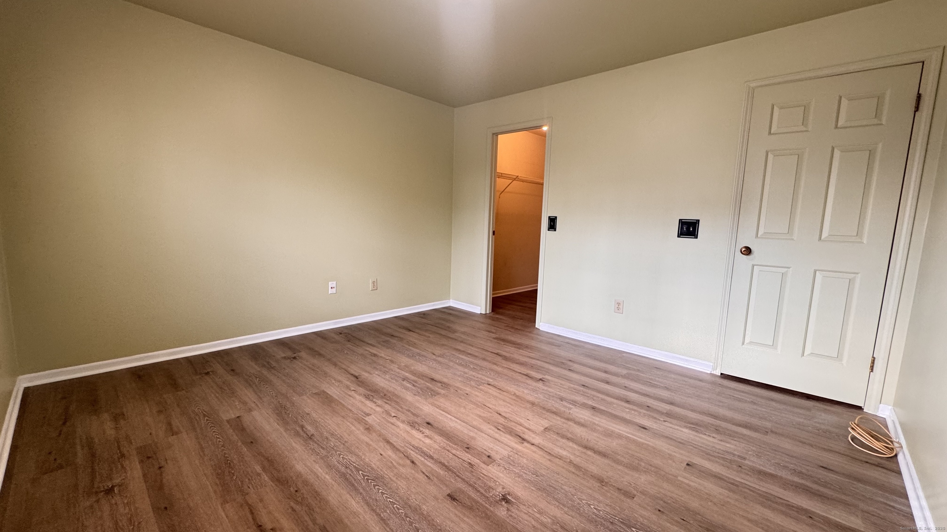 25 Janet Circle, Unit F Bridgeport, CT 06606 - Photo 12 of 22 a view of an empty room with wooden floor