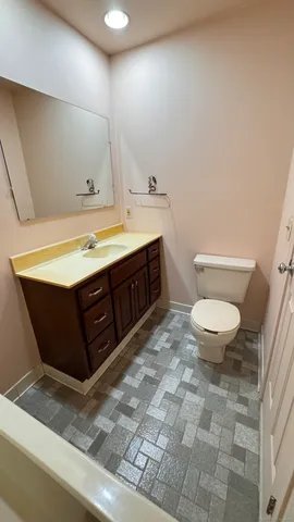 a bathroom with a sink a toilet and a mirror