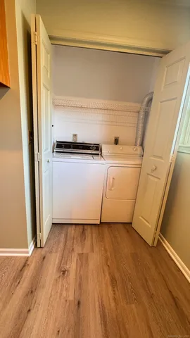 a view of washer and dryer with wooden floor