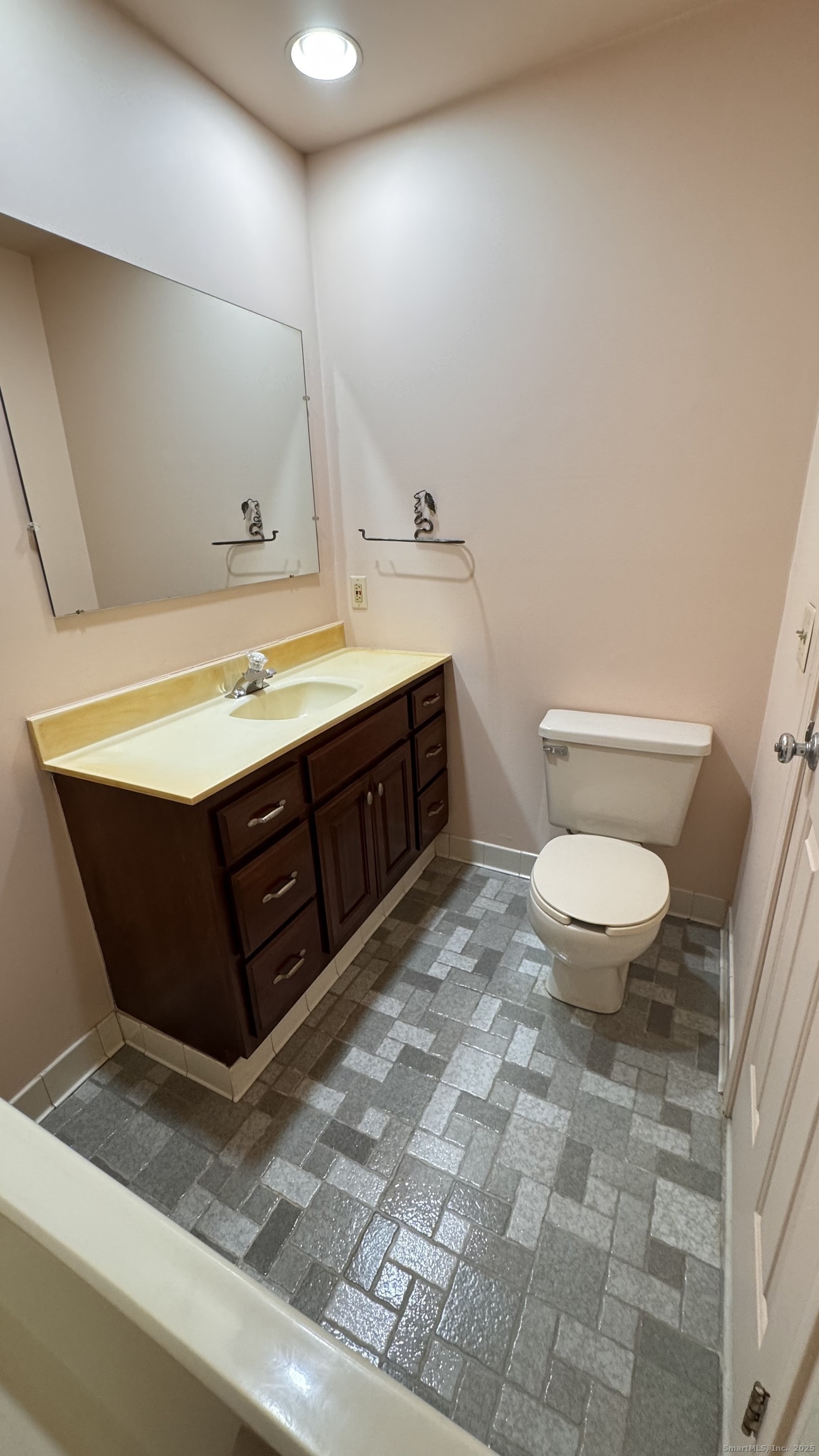 25 Janet Circle, Unit F Bridgeport, CT 06606 - Photo 16 of 23 a bathroom with a sink a toilet and a mirror