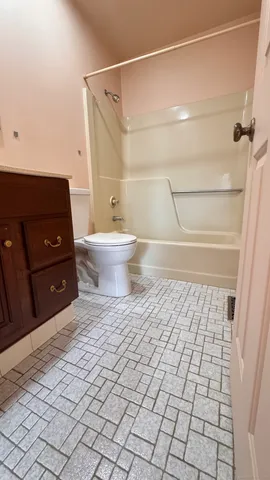a view of empty room with wooden floor and floor to ceiling window