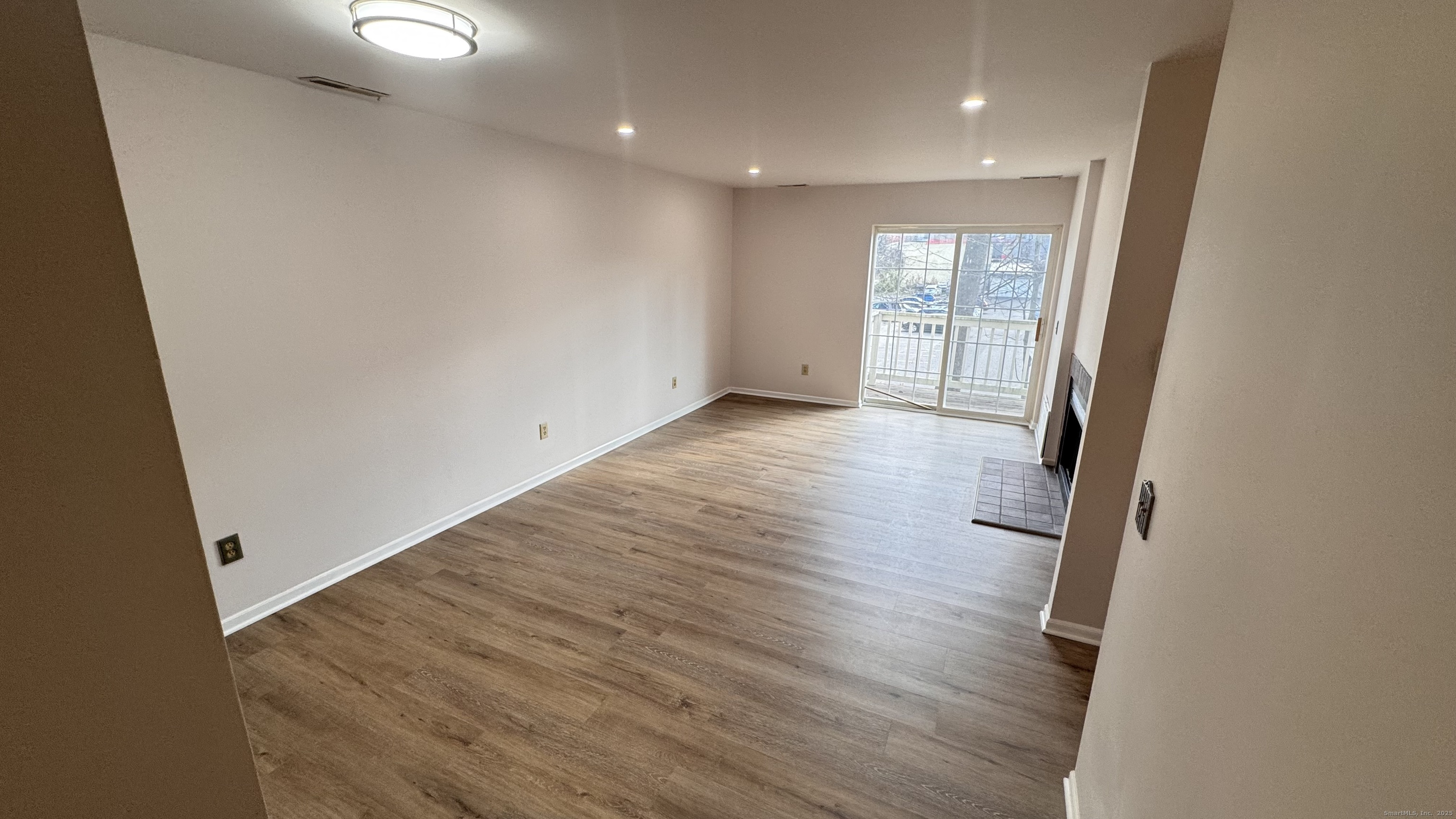 25 Janet Circle, Unit F Bridgeport, CT 06606 - Photo 2 of 22 wooden floor in an empty room with a window