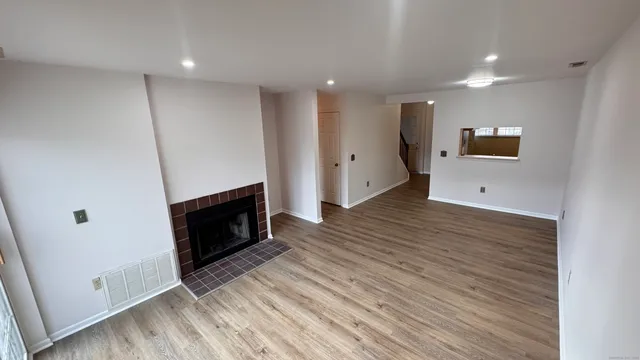 a room with wooden floor and fire place