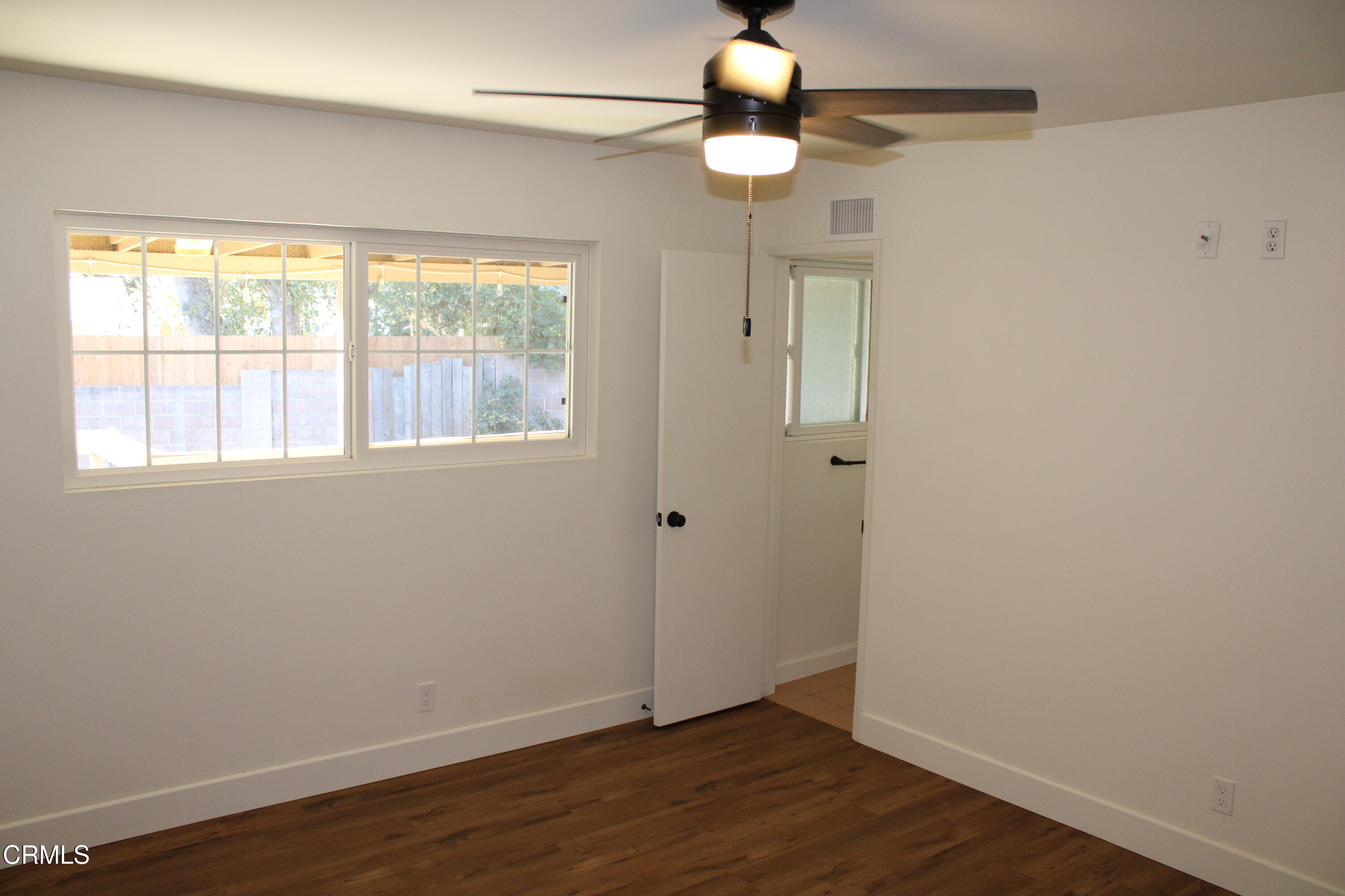 866 Cambon Circle Ojai, CA 93023 - Photo 14 of 27 an empty room with wooden floor and windows