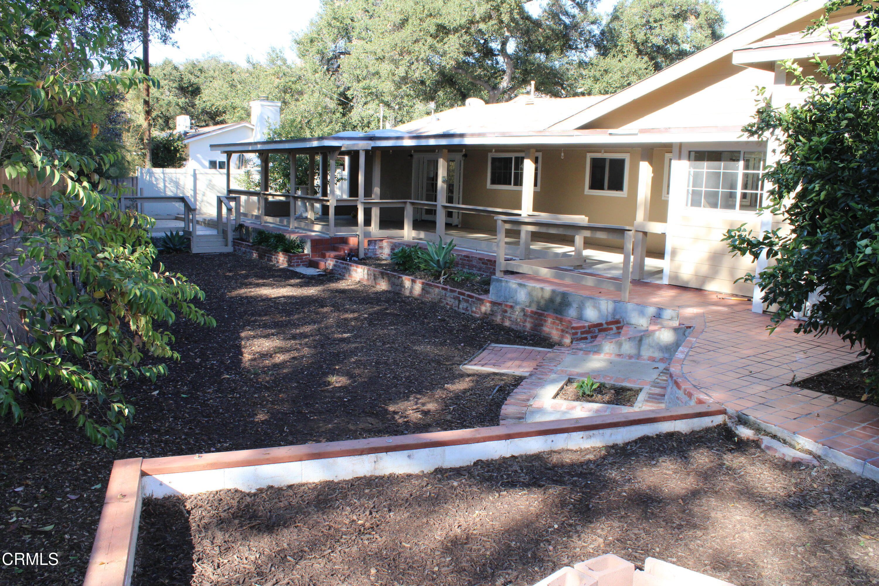 866 Cambon Circle Ojai, CA 93023 - Photo 27 of 27 a view of a backyard with table and chairs potted plants and large tree