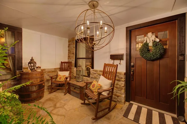 a very nice looking room with many windows and furniture