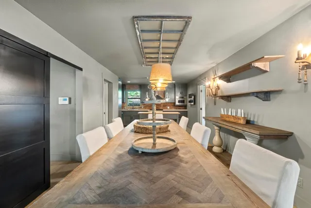 a living room with furniture fireplace and chandelier