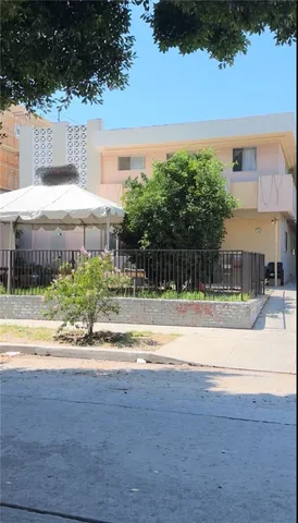 a view of car parked on road with large trees