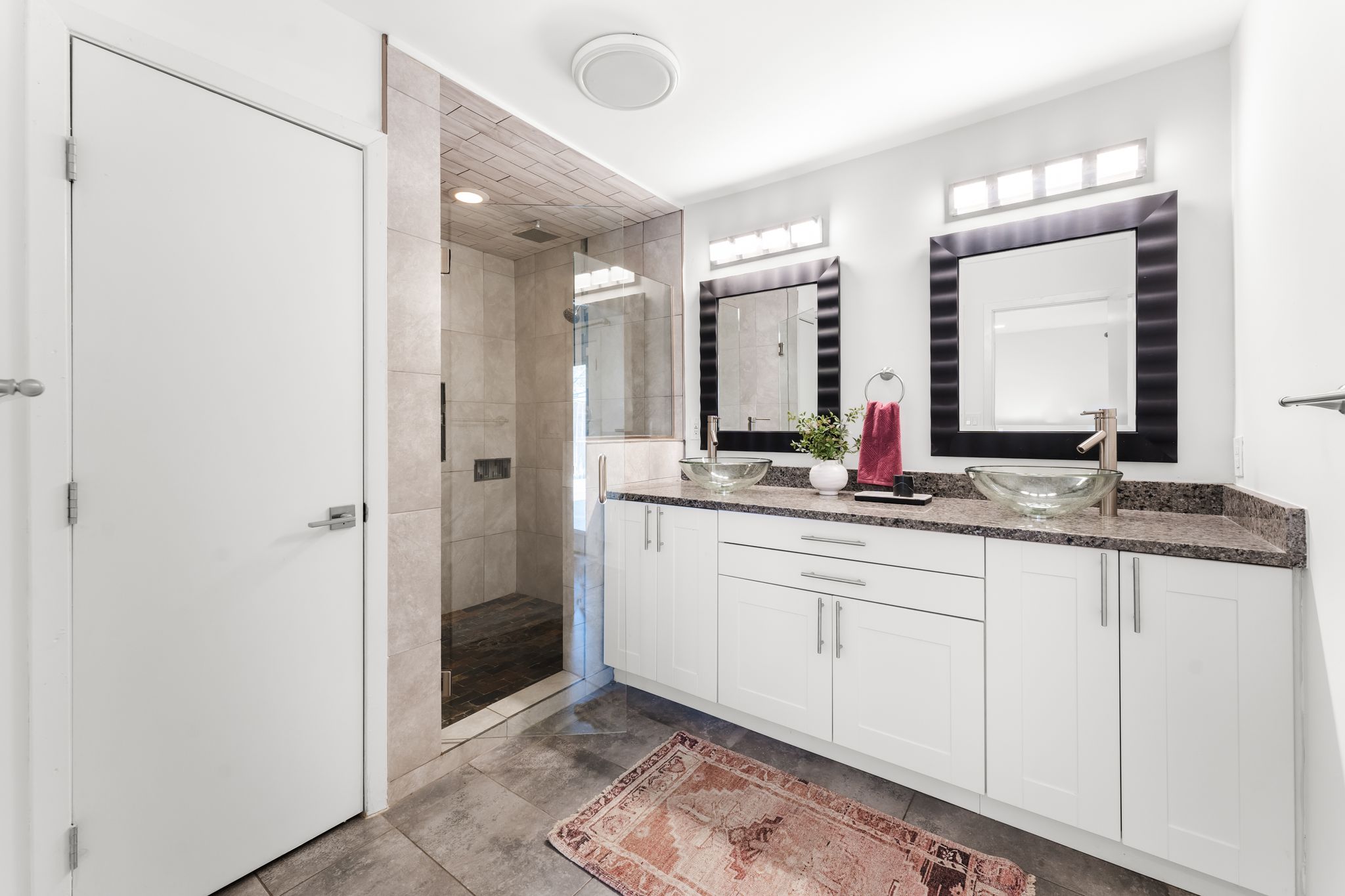 1900 Ohlen Road Austin, TX 78757 - Photo 23 of 34 a bathroom with a double vanity sink and a mirror