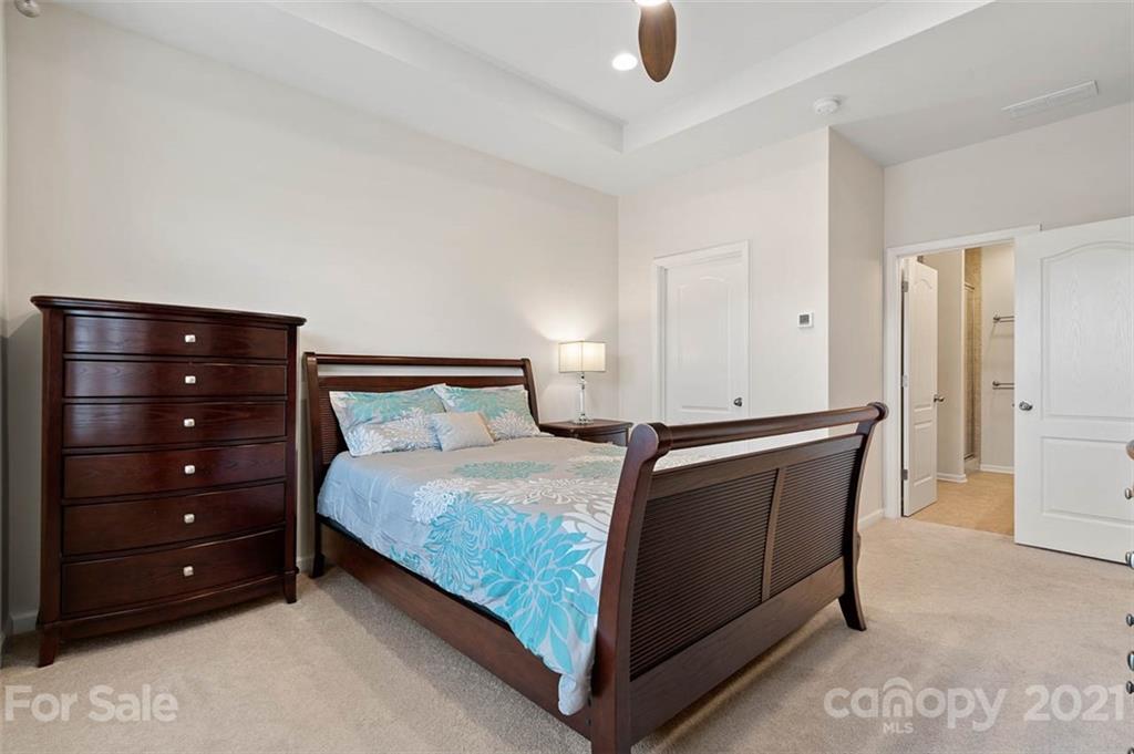 212 Butterfly Place, Unit 188 Tega Cay, SC 29708 - Photo 14 of 33 a bedroom with a bed and a dresser