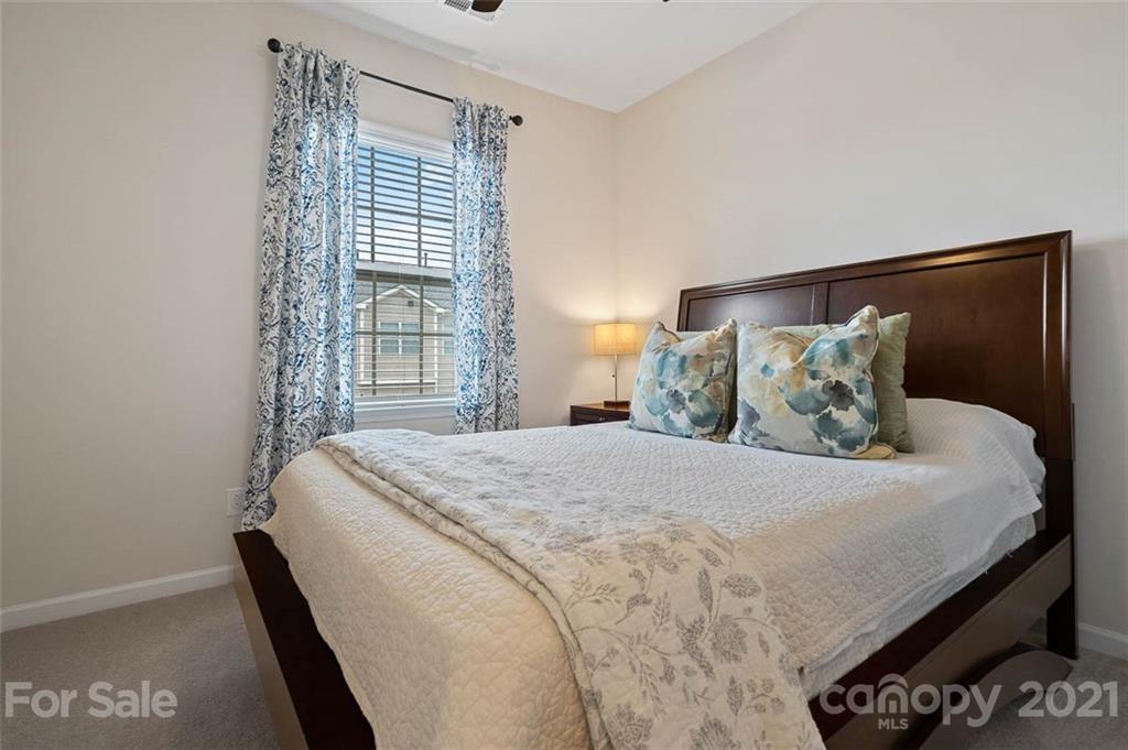 212 Butterfly Place, Unit 188 Tega Cay, SC 29708 - Photo 8 of 33 a bedroom with a bed and window