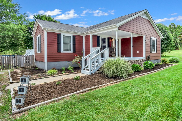 148 Thomas Road Livingston, TN 38570 - Photo 1 of 38 a front view of a house with garden