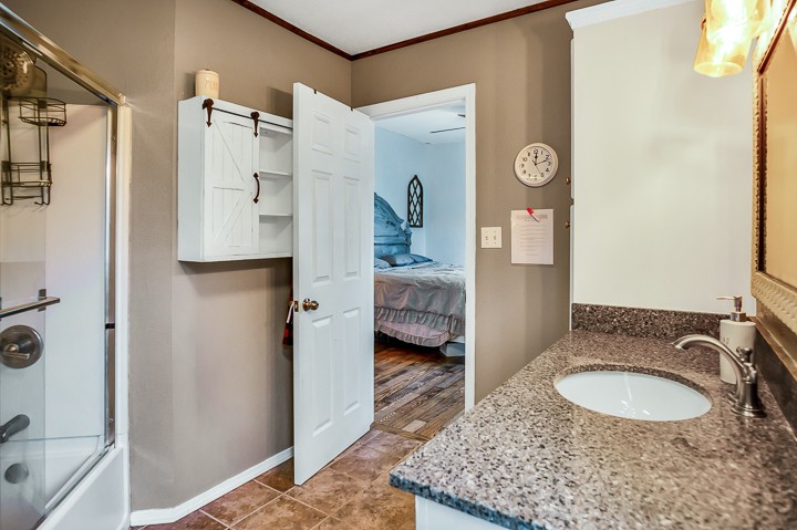 148 Thomas Road Livingston, TN 38570 - Photo 17 of 38 a bathroom with a granite countertop sink and a mirror