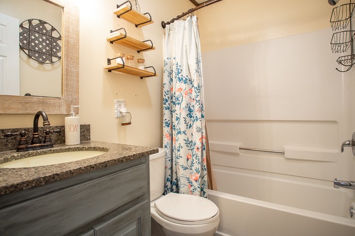148 Thomas Road Livingston, TN 38570 - Photo 23 of 38 a bathroom with a granite countertop sink toilet and shower