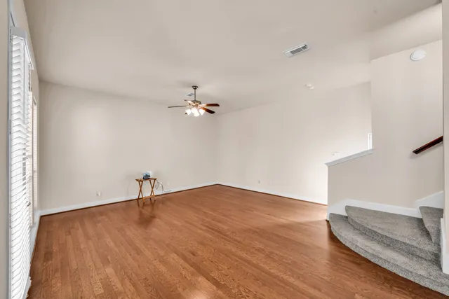 wooden floor in an empty room with a window
