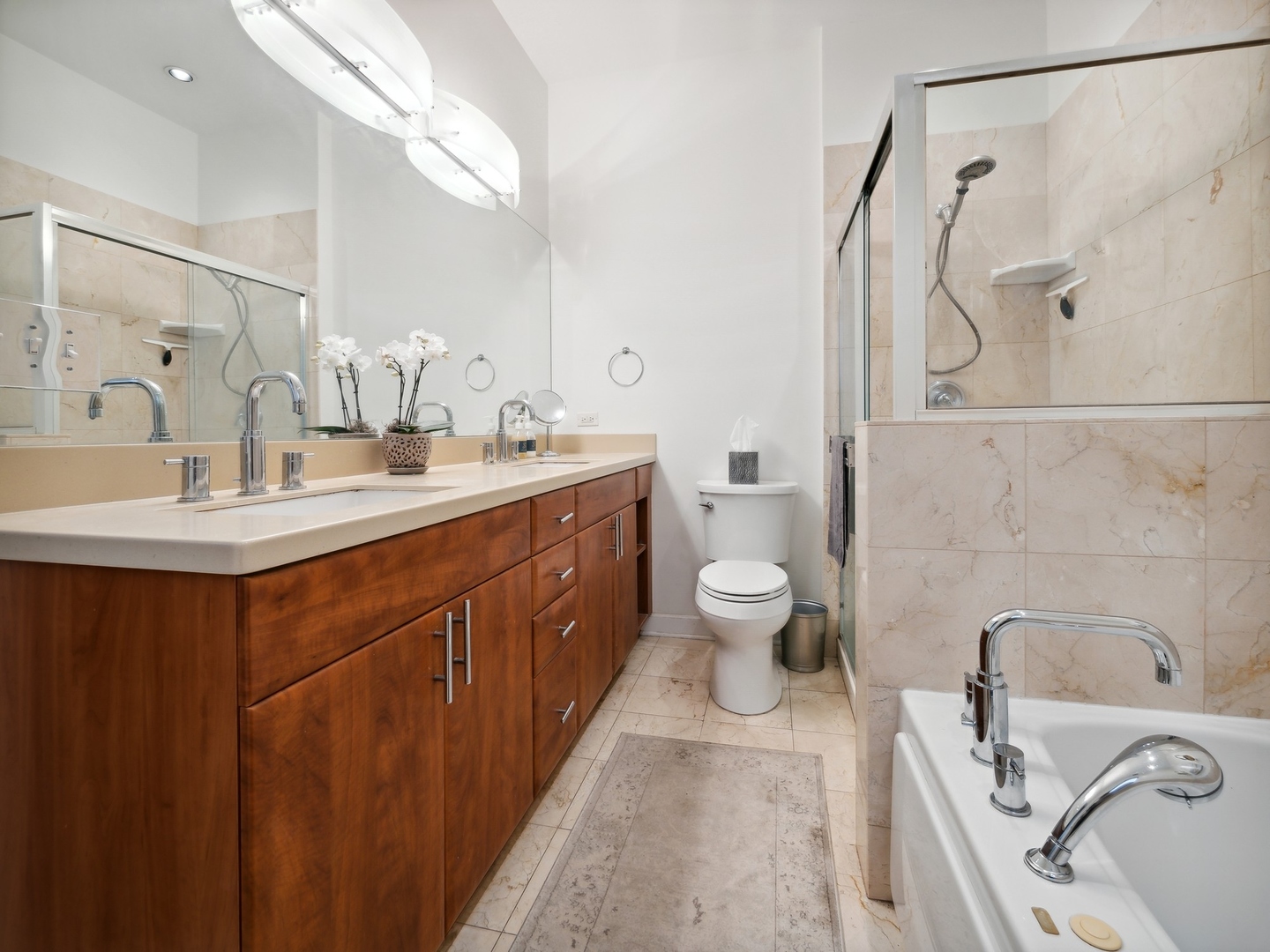 1827 West Addison Street, Unit 2 Chicago, IL 60613 - Photo 12 of 18 a en suite bathroom with a double vanity sink toilet mirror and shower