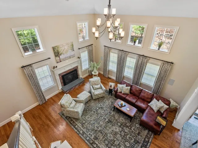 a living room with furniture and a chandelier