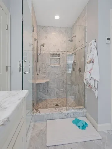 a bathroom with a bathtub and shower