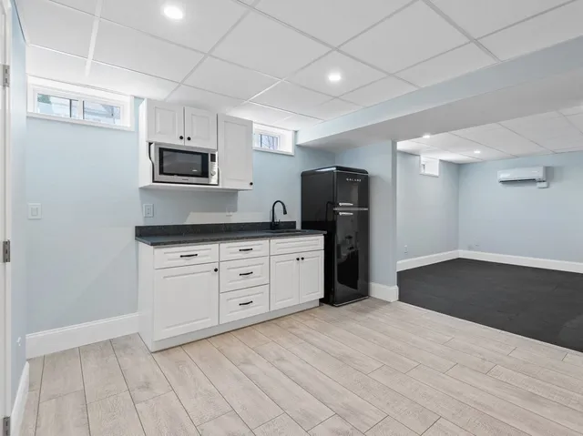 a kitchen with stainless steel appliances a refrigerator sink and microwave