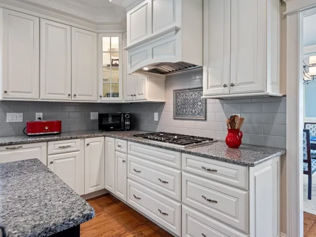 a kitchen with stainless steel appliances granite countertop a stove sink and cabinets