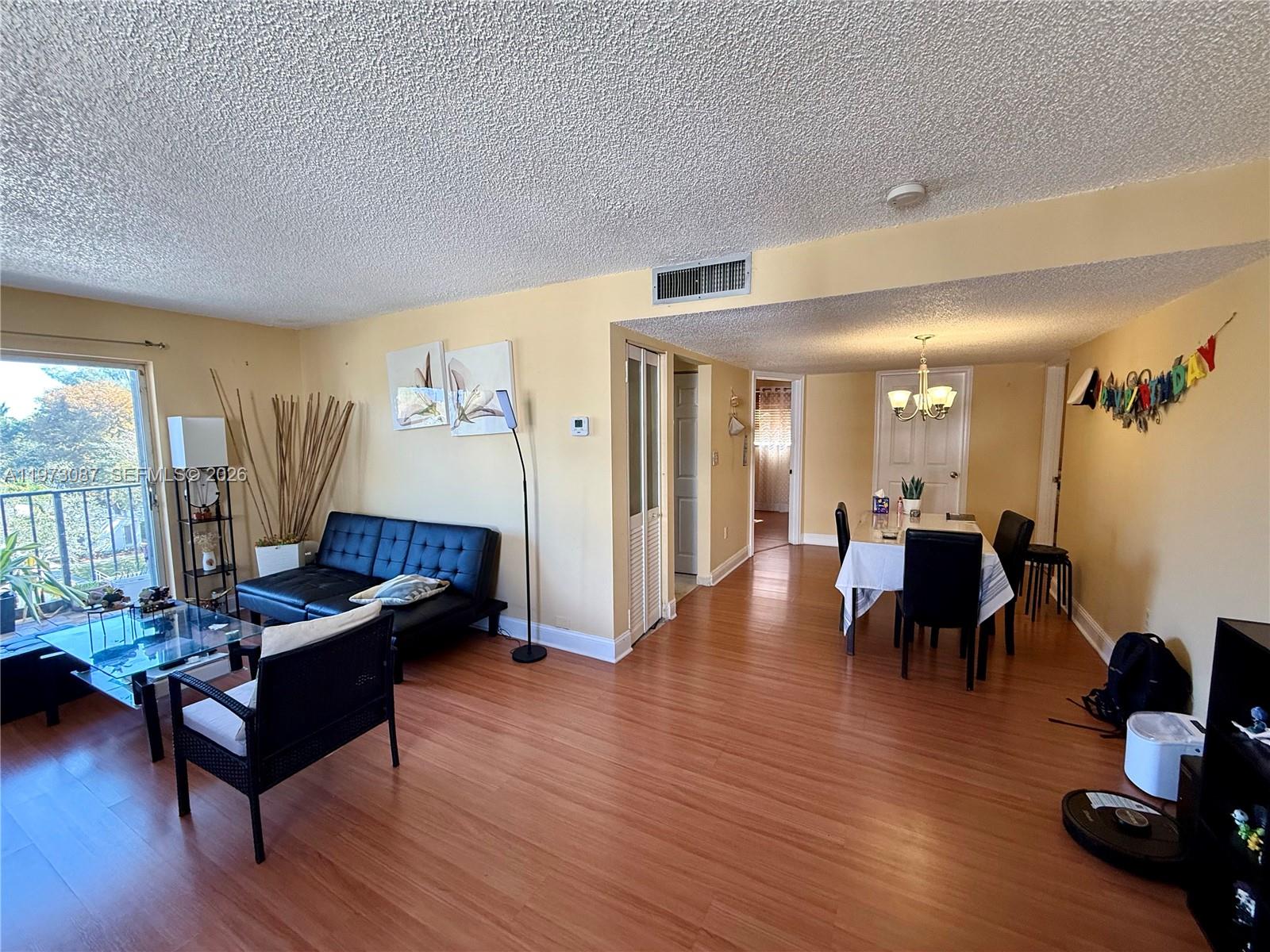 1236 Alton Road, Unit 401 Miami Beach, FL 33139 - Photo 1 of 14 a living room with furniture and wooden floor