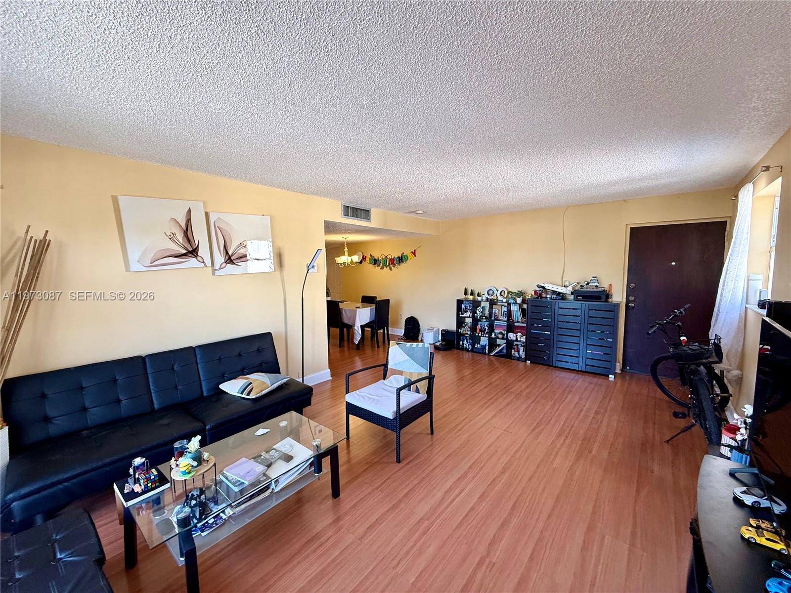 1236 Alton Road, Unit 401 Miami Beach, FL 33139 - Photo 3 of 14 a living room with furniture and a flat screen tv