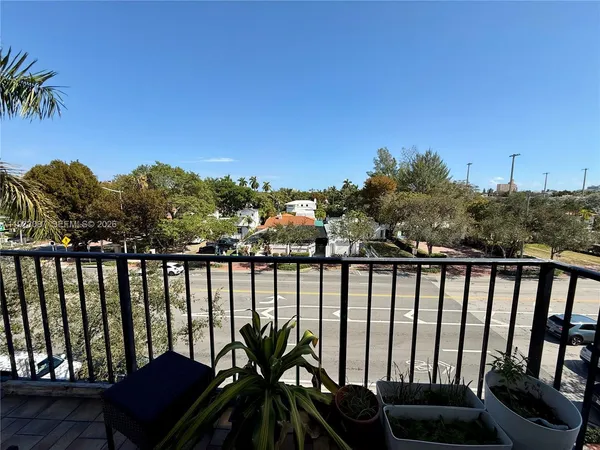 a view of a balcony with chairs and a table