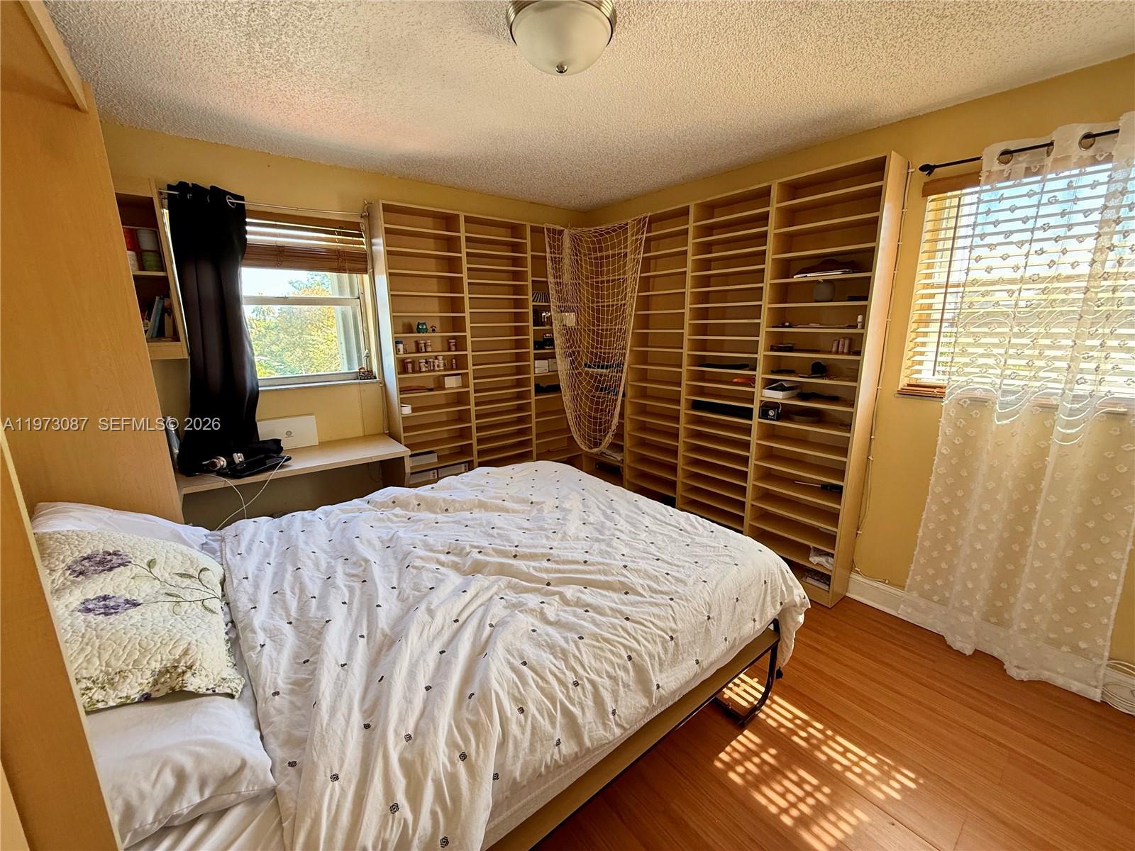 1236 Alton Road, Unit 401 Miami Beach, FL 33139 - Photo 9 of 14 a bedroom with a bed and a television