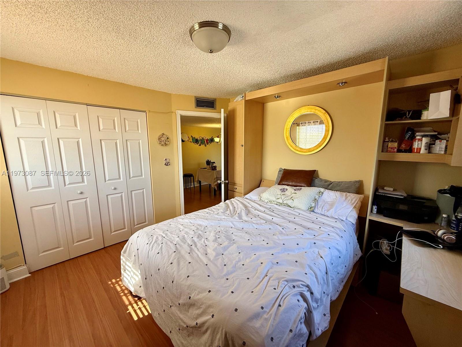 1236 Alton Road, Unit 401 Miami Beach, FL 33139 - Photo 10 of 14 a bedroom with a bed and a closet