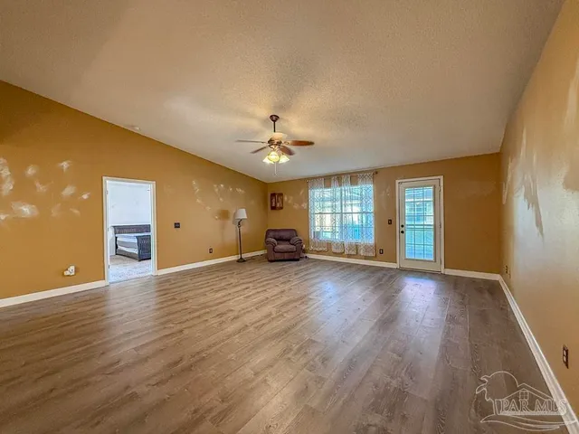 a bedroom with a bed and a ceiling fan