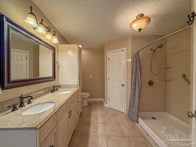a bathroom with a shower and a mirror