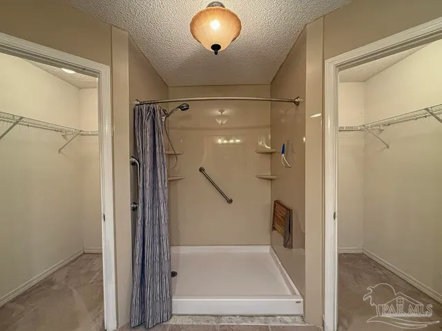 a spacious bathroom with a toilet sink and mirror