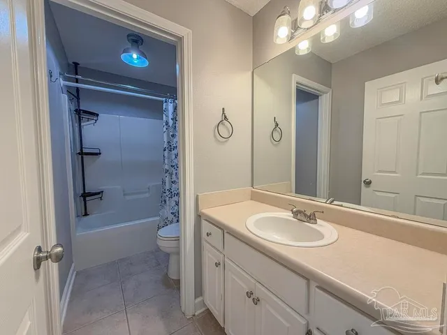 a white toilet sitting next to a bath tub