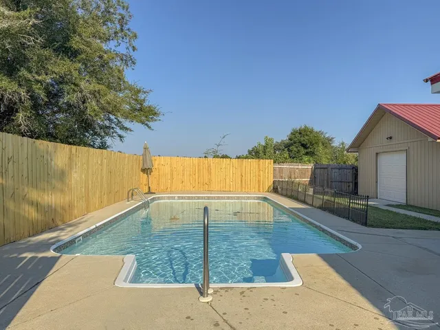 a backyard of a house with table and chairs