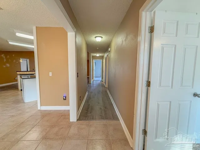 a view of an empty room with a fireplace and a window